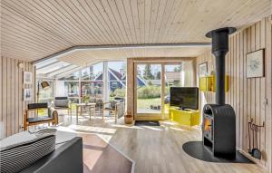 a living room with a wood burning stove in it at Holiday Home Gøgeurtvej Væggerløse X in Marielyst
