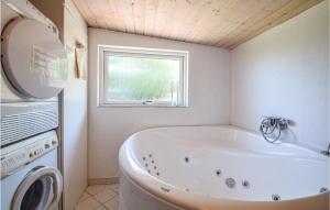 a white bath tub in a bathroom with a window at Beautiful Home In Bjert With Wifi in Sønder Bjert