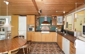 une cuisine avec des placards en bois et une table en bois dans l'établissement Pet Friendly Home In Gedser With Wifi, à Gedser