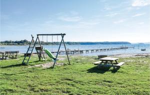 a park with a swing and a picnic table at Stunning Home In Rnde With Kitchen in Rønde