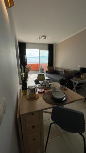 a living room with a table and a couch at Besonderes Apartment mit einzigartigem Meerblick in Costa Calma