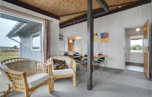 a room with a table and chairs and a dining room at Hedebo in Fanø