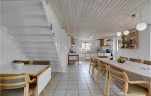 a kitchen and dining room with a table and chairs at Pet Friendly Home In Christiansfeld With Sauna in Christiansfeld