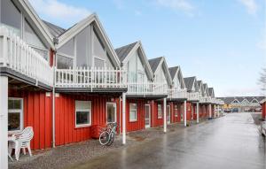 a row of red houses with a bike parked outside at Hasle Marina in Hasle