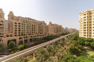a view of a city with tall buildings and palm trees at Spacious 3 Bed Room Apartment - Palm Jumeirah Dubai in Dubai