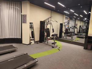 a gym with several treadmills and elliptical machines at SSAW Boutique Hotel Hangzhou Yilian in Hangzhou
