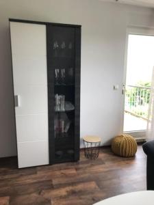 a living room with a black cabinet with wine glasses at Haus Eierhof in Papenburg
