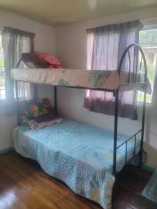 a bedroom with two bunk beds and a blue mattress at MAK Homstay upstairs in Kundasang