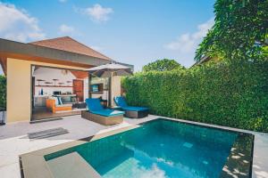 a backyard with a swimming pool and a house at Allure Resort in Choeng Mon Beach