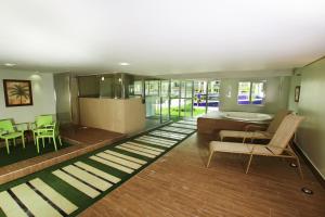 a living room with a couch and a table and chairs at Sun Residence in Fortaleza