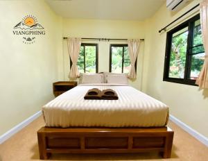 Postel nebo postele na pokoji v ubytování ViangPhing Resort + 19 fotografií