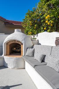 a stone pizza oven with two pillows on a patio at Santorini in Glendale