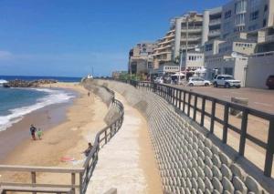 a view of a beach with buildings and the ocean at 84 Camarque Umdloti beach in Umdloti