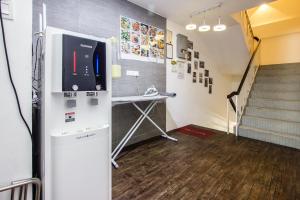 a room with a refrigerator and a table and stairs at Nice Inn in George Town +70 photos