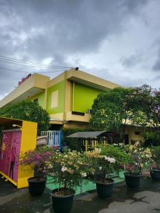 a building with a bunch of plants in front of it at RedDoorz Plus near Dunia Fantasi Ancol in Jakarta