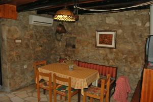 a dining room with a table and chairs and a ceiling at Village House in Cres