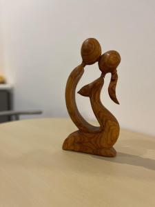 a wooden figurine of two people holding hands at LuanaApartments # 43 in Otopeni