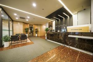 a lobby with chairs and a reception desk in a building at Jamsil Stay Hotel in Seoul