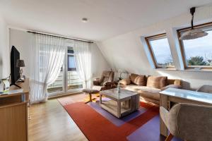 a living room with a couch and a table at Haus Liberty 1 in Büsum