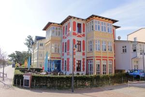 a tall building with colorful windows on a street at Villa-Emmy-App-02 in Ahlbeck