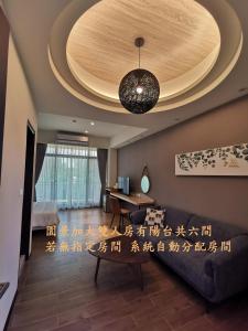 a living room with a ceiling with chinese writing on it at Meets Anping in Anping