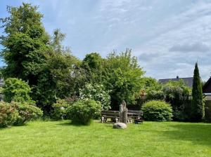 a park with a bench in the grass at Haus Sonnenwinkel, FW 3 in Zingst