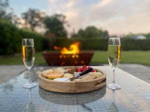 a table with two glasses of wine and a plate of food at 100 acres of mountain paradise all to yourself in Berry