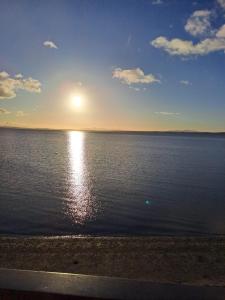 a sunset over a large body of water at Relaxing cottage with spectacular view, Sauna and Spa Pool in Kircubbin