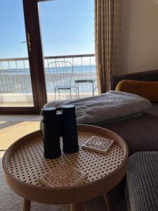 a room with a table with two trash cans on it at Relaxing cottage with spectacular view, Sauna and Spa Pool in Kircubbin