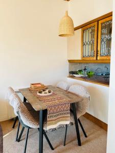 a kitchen with a wooden table and chairs at Relaxing cottage with spectacular view, Sauna and Spa Pool in Kircubbin