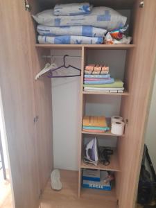 a book shelf with towels and towels on it at Apartment Luka in Podgorica