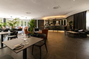 a restaurant with tables and chairs and a bar at Hotel Da Vinci in Milan