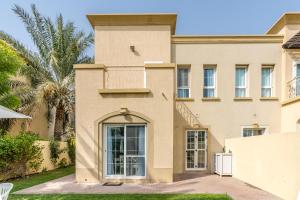 a house with a balcony on the side of it at Lux BnB Springs Villa Private Garden in Dubai