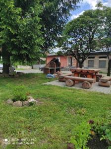 a park with a picnic table in the grass at Dawna Mleczarnia Apartamenty MIODOWY in Nowa Ruda