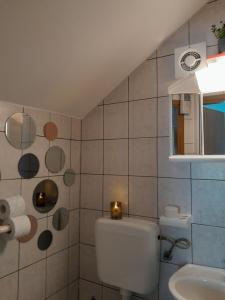 a bathroom with a toilet and a sink at Studio Silvana & Room Renata in Lumbarda
