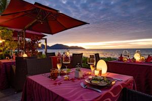 a table with a pink table cloth with wine glasses at PARKROYAL Penang Resort in Batu Ferringhi