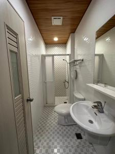 a bathroom with a sink and a toilet at Kenting Sea Cloudless Day Home in Kenting