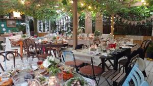 a restaurant with tables and chairs with food on them at Ulęgałki Roztocze Stodoła in Jacnia