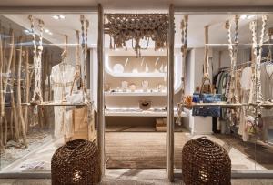 a dressing room with a display case with clothes at Kythnos Bay Hotel in Loutra