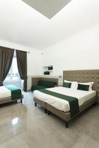 a bedroom with two beds and a large window at Vaticano Luxury Guest House in Rome