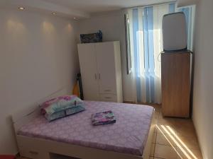 a room with a bed with two pillows on it at DIANA Seaside Holiday in Olimp
