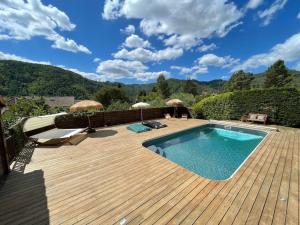 a wooden deck with a swimming pool and a wooden floor at Le Chalet - Les Lodges de Praly in Les Ollières-sur-Eyrieux