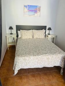 a bedroom with a large bed with two night stands at VV Faro in Puerto de Mogán