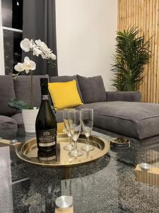 a bottle of wine on a table with two wine glasses at Complete Osborne House by Prescott Apartments in Bristol