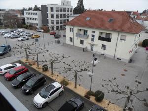 a parking lot with cars parked in front of a building at # STUDIO BON EMPLACEMENT AVEC PARKING # in Illzach