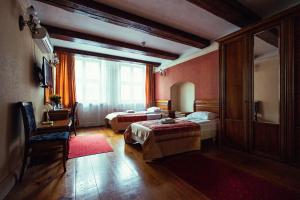 a hotel room with two beds and a window at Heban Hotel in Toruń