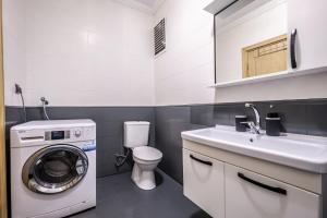 a bathroom with a washing machine and a sink at Comfy in Istanbul