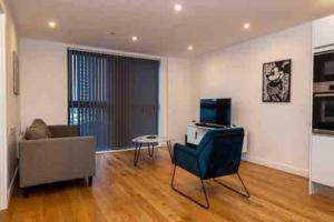 a living room with a couch and a chair at 1 Bed In Birmingham City Centre in Birmingham