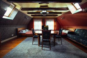 a dining room with a table and chairs and a bed at Heban Hotel in Toruń