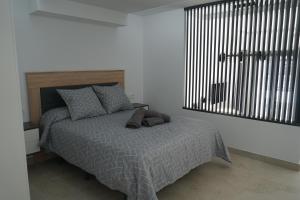 Łóżko lub łóżka w pokoju w obiekcie Apartamento Turistico Hermanos Infantes